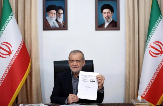 Iranian President Masoud Pezeshkian holding a document