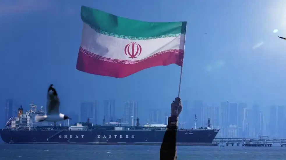 Iranian flag above a tanker near port